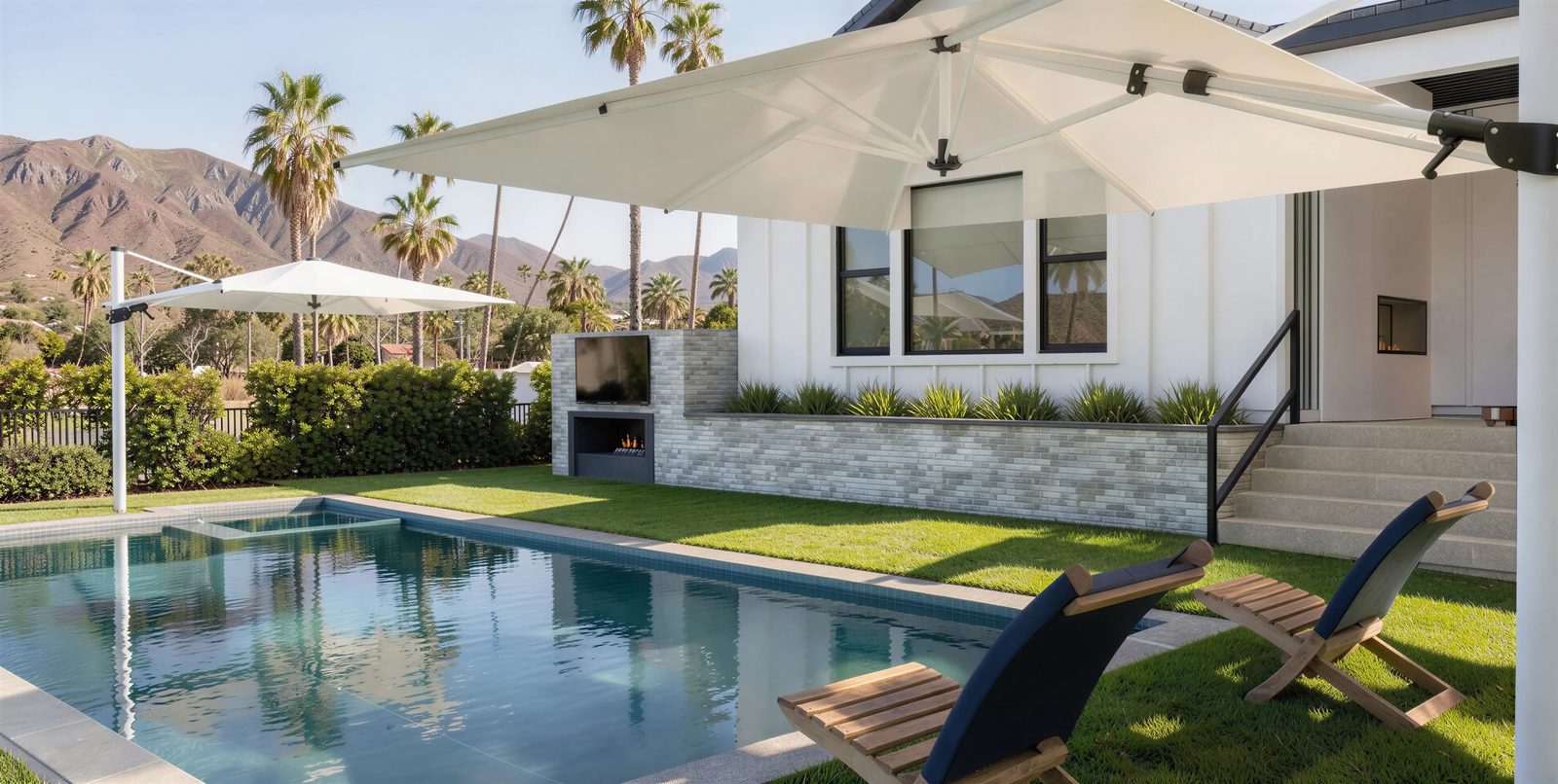 3D design rendering of a lap pool with a brick fireplace and TV wall, cantilever umbrellas and mountain views for a Poway backyard